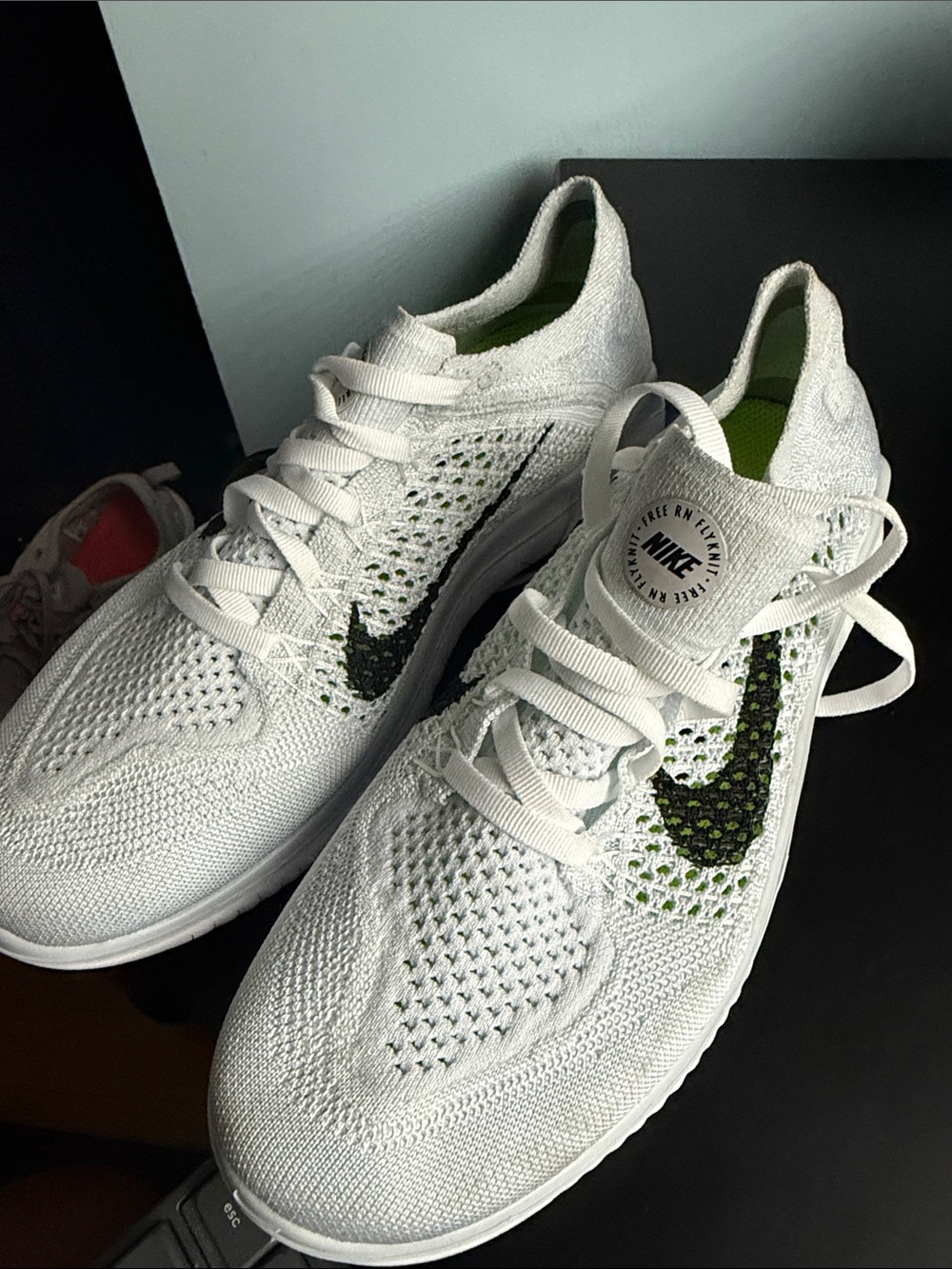 Nike White Flyknit Sneakers with Green Swoosh